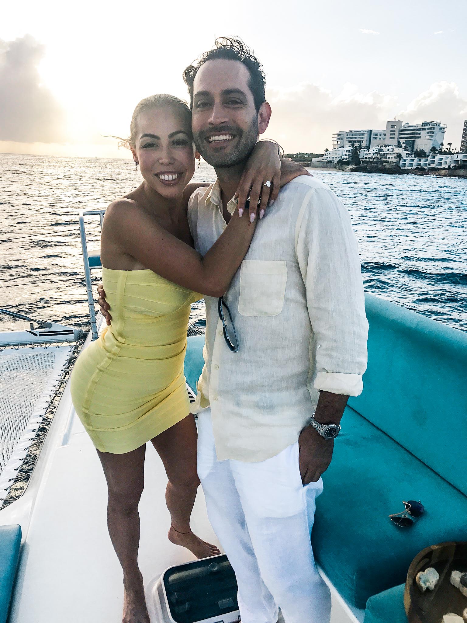Couple embracing on Random Wind catamaran yacht