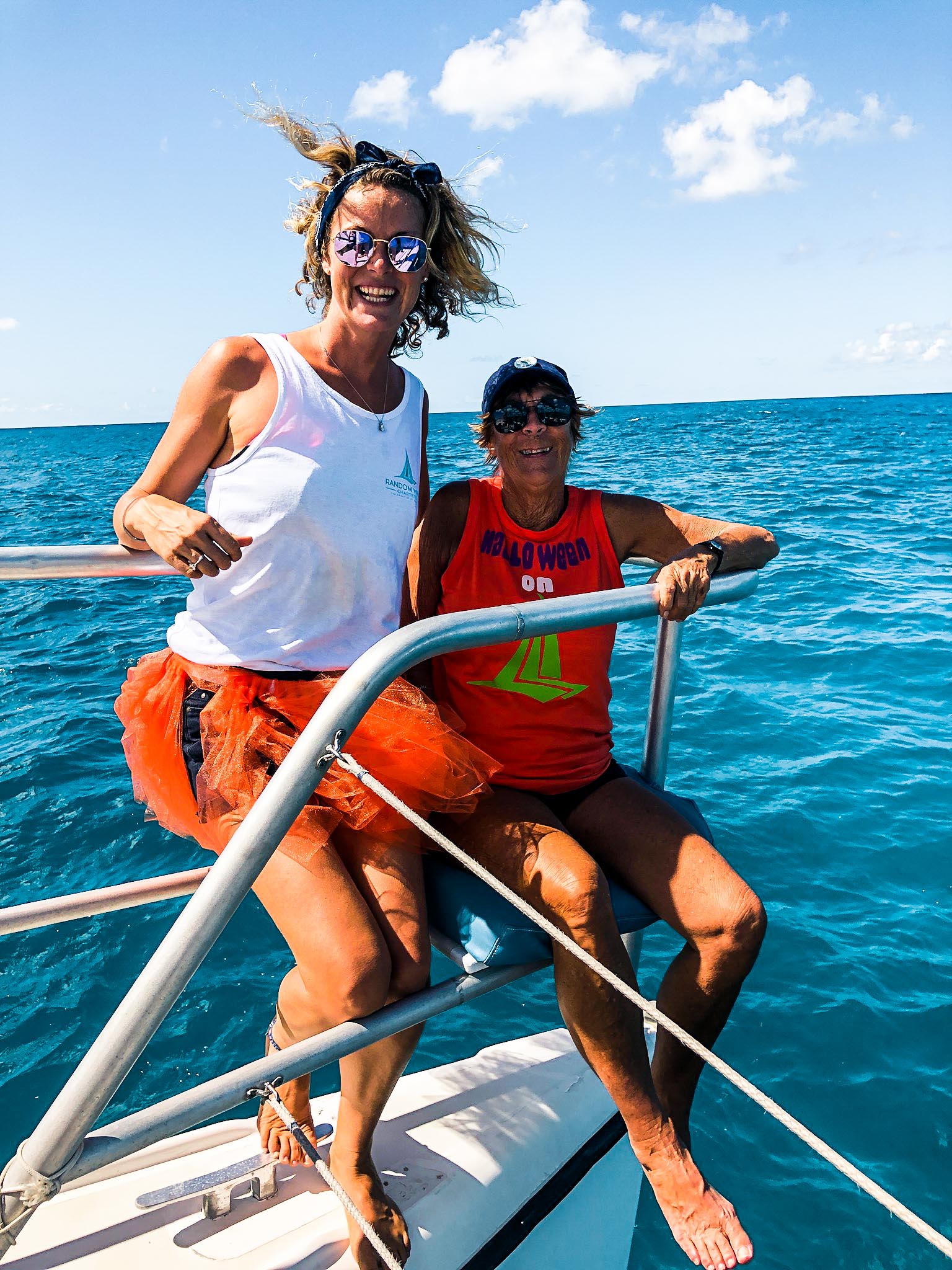 Two adults sitting at front of Random Wind yacht
