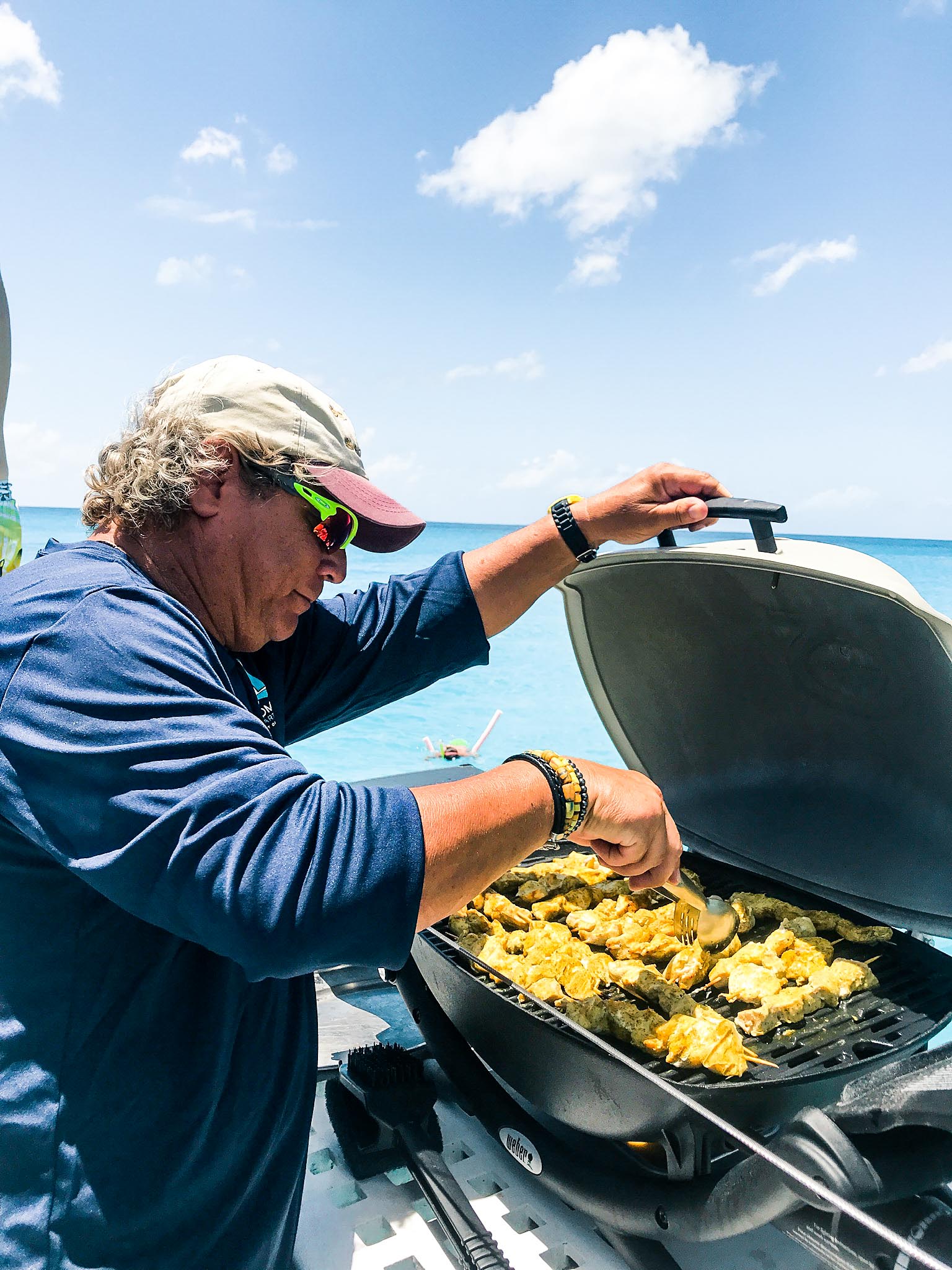 Random Wind employee grilling chicken