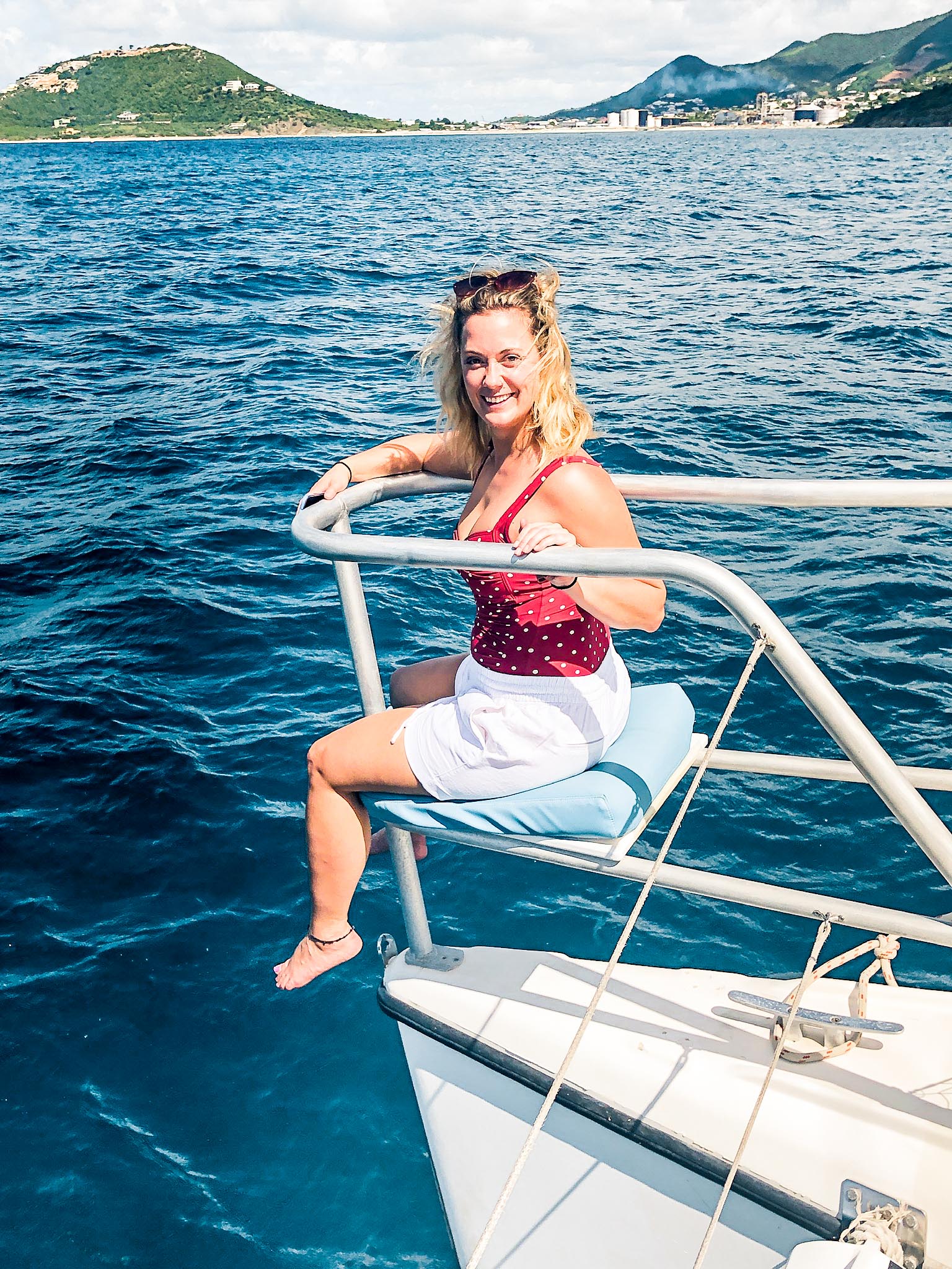 Young woman sitting at front of Random Wind yacht