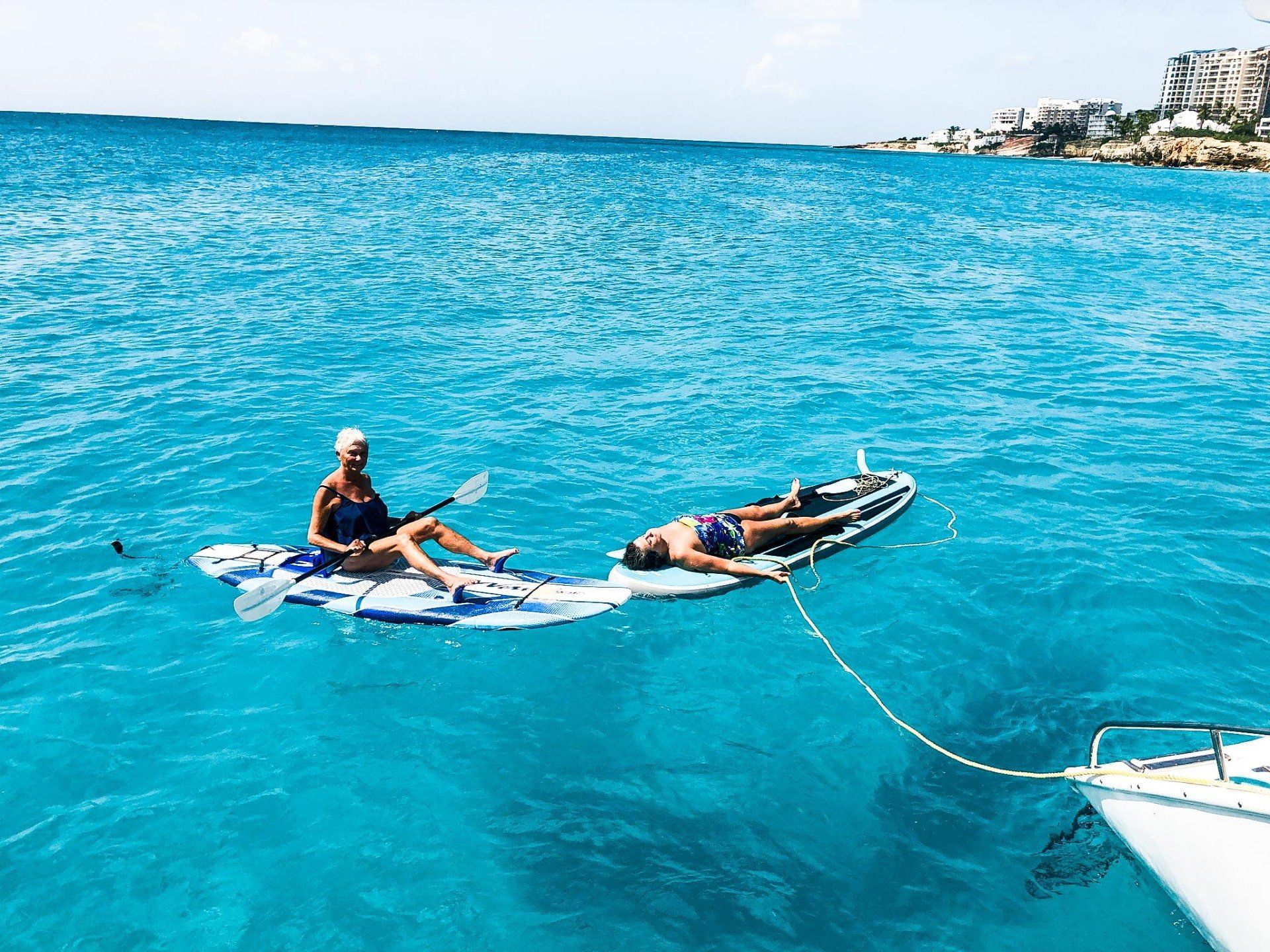 Two people sitting on stand-up paddleboards