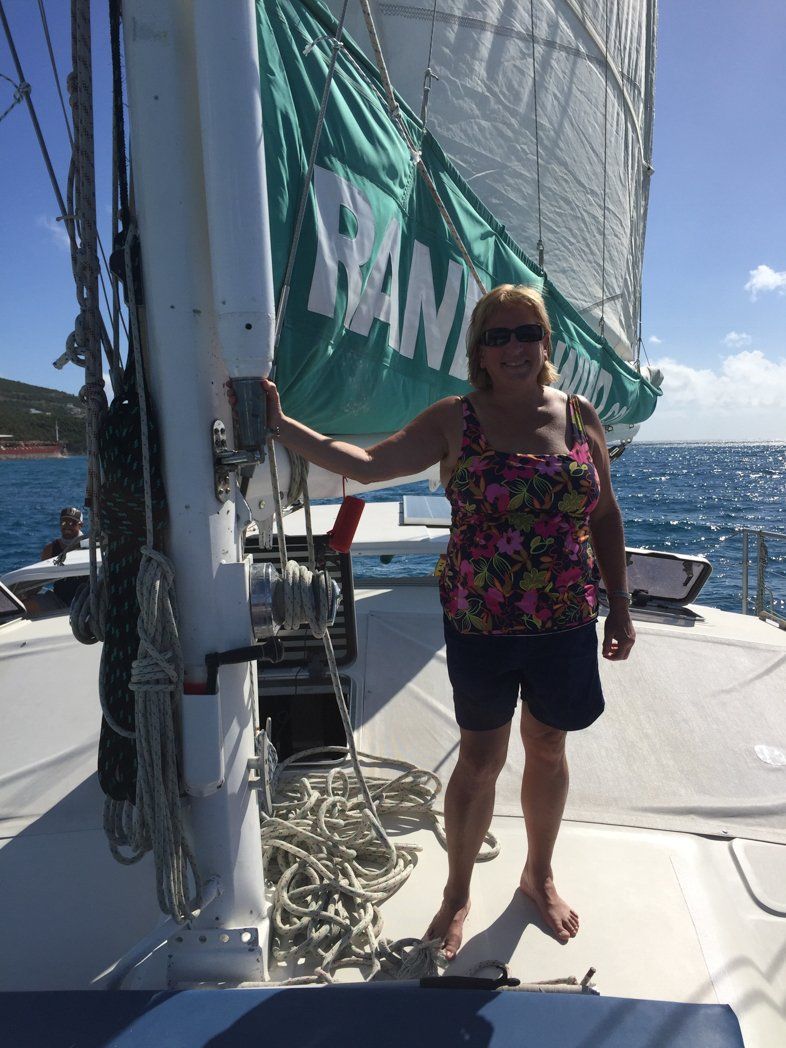 Woman standing by sail on Random Wind yacht