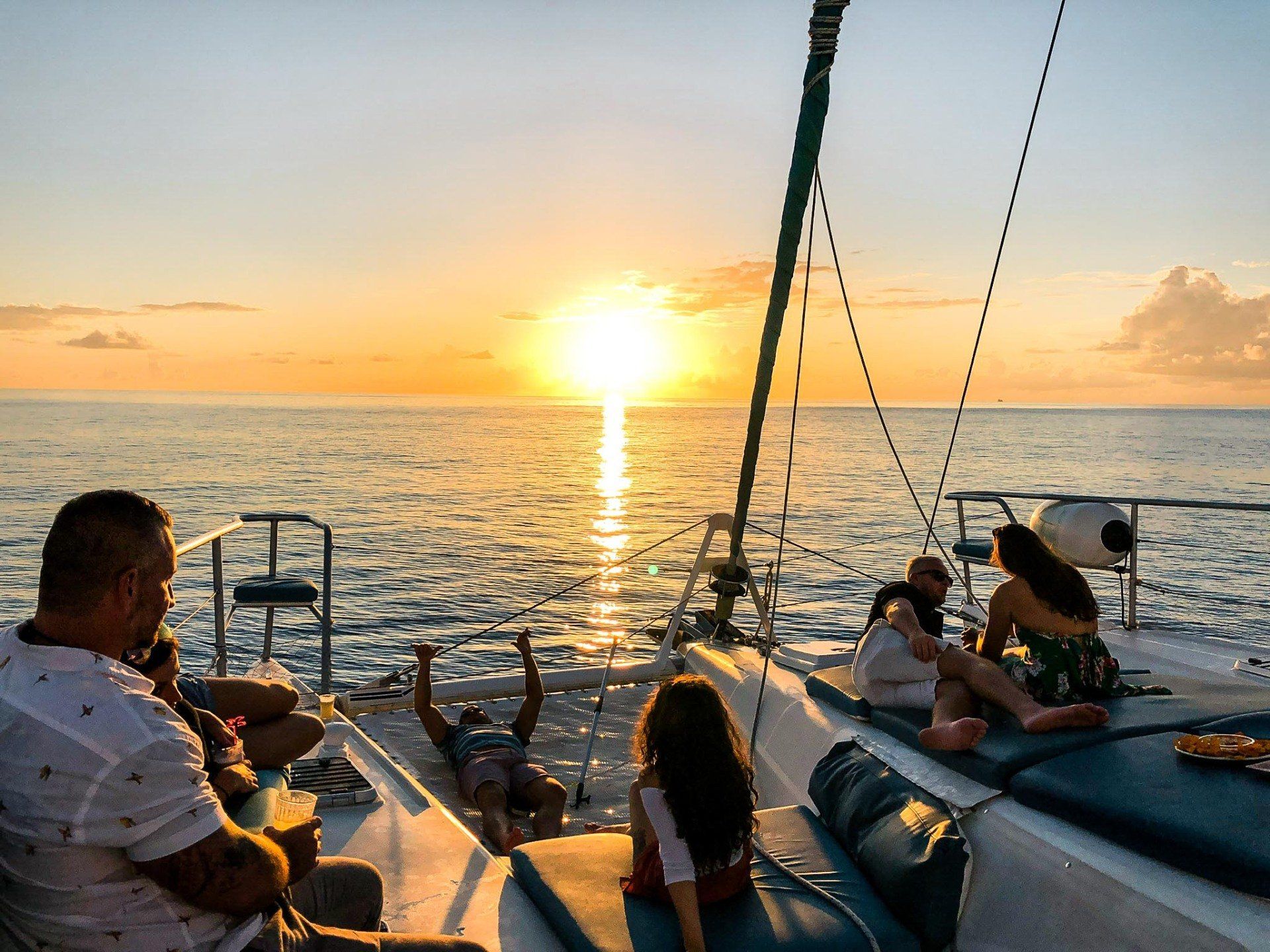 Family watching sunset in St Maarten from Random Wind Yacht