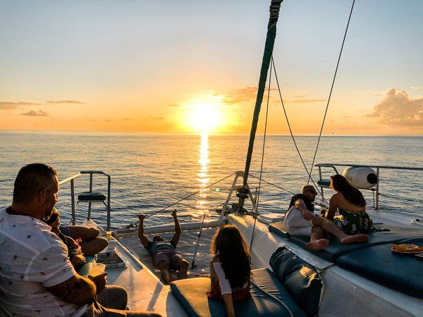 Family watching sunset in St Maarten from Random Wind Yacht Charter