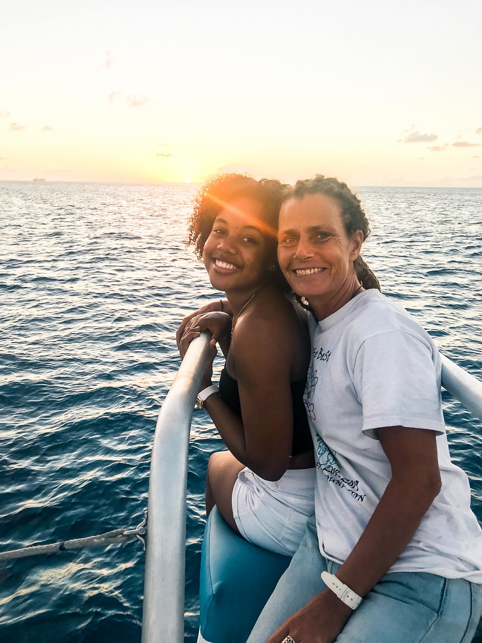 Two women sitting on catamaran yacht charter