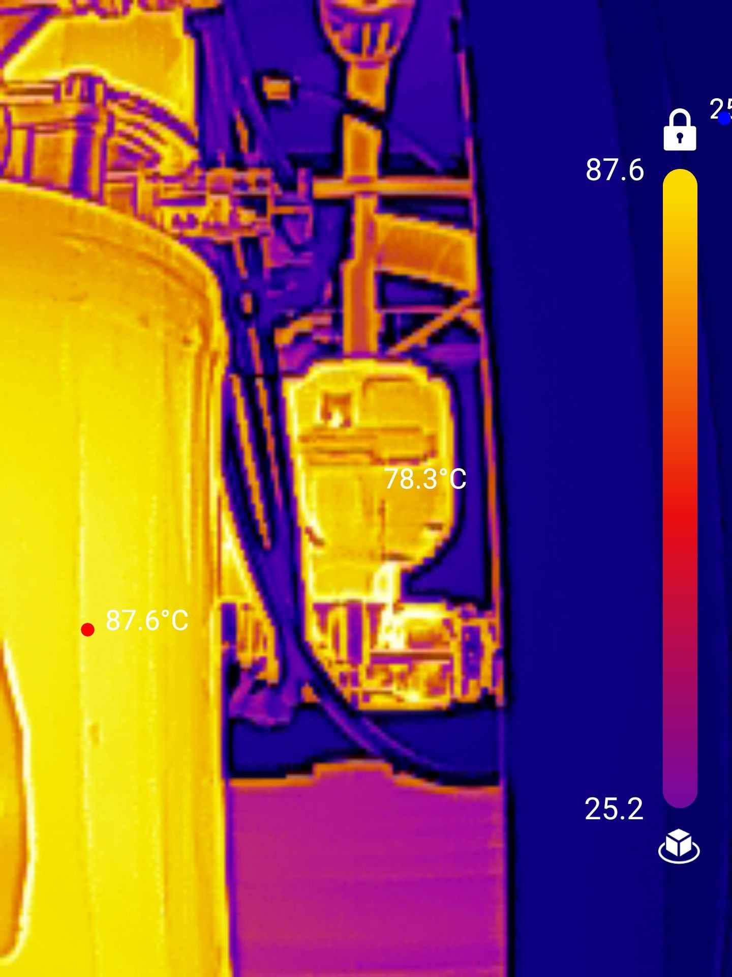 A thermal image of a machine with a thermometer on it.