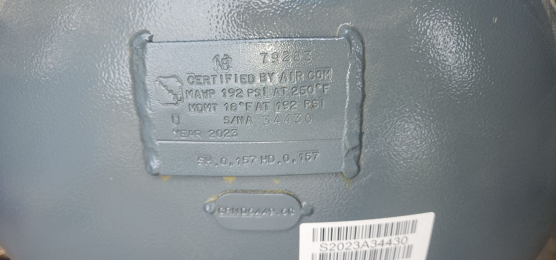 A close up of a metal object with a label on it.