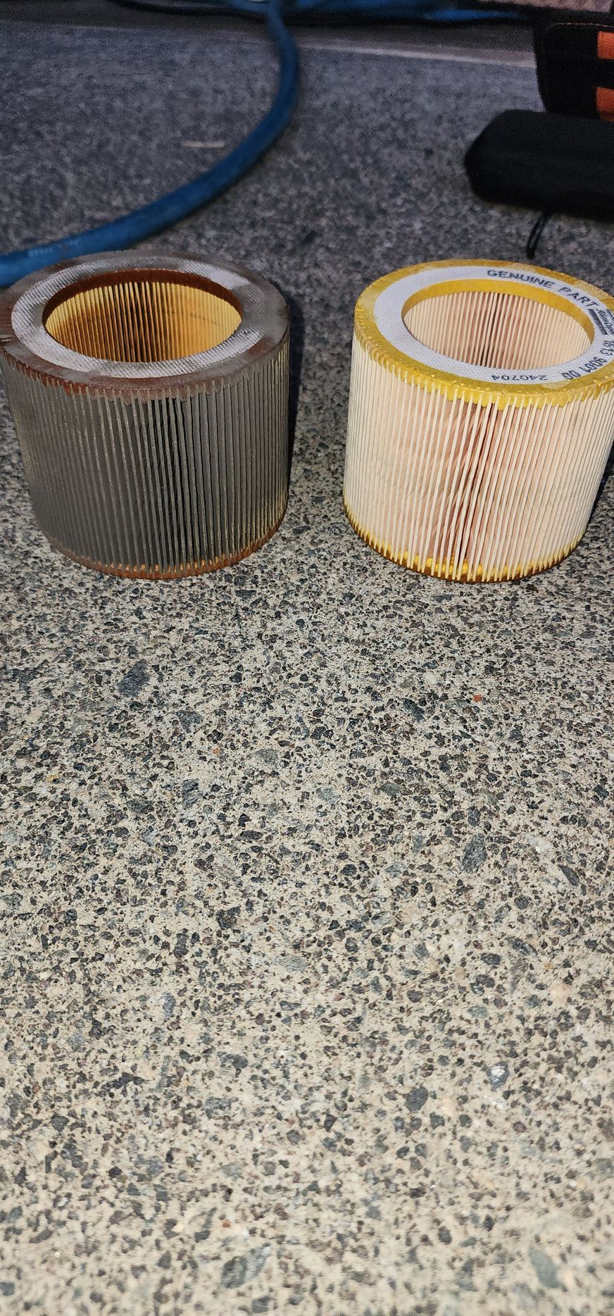 Two air filters are sitting next to each other on a table.