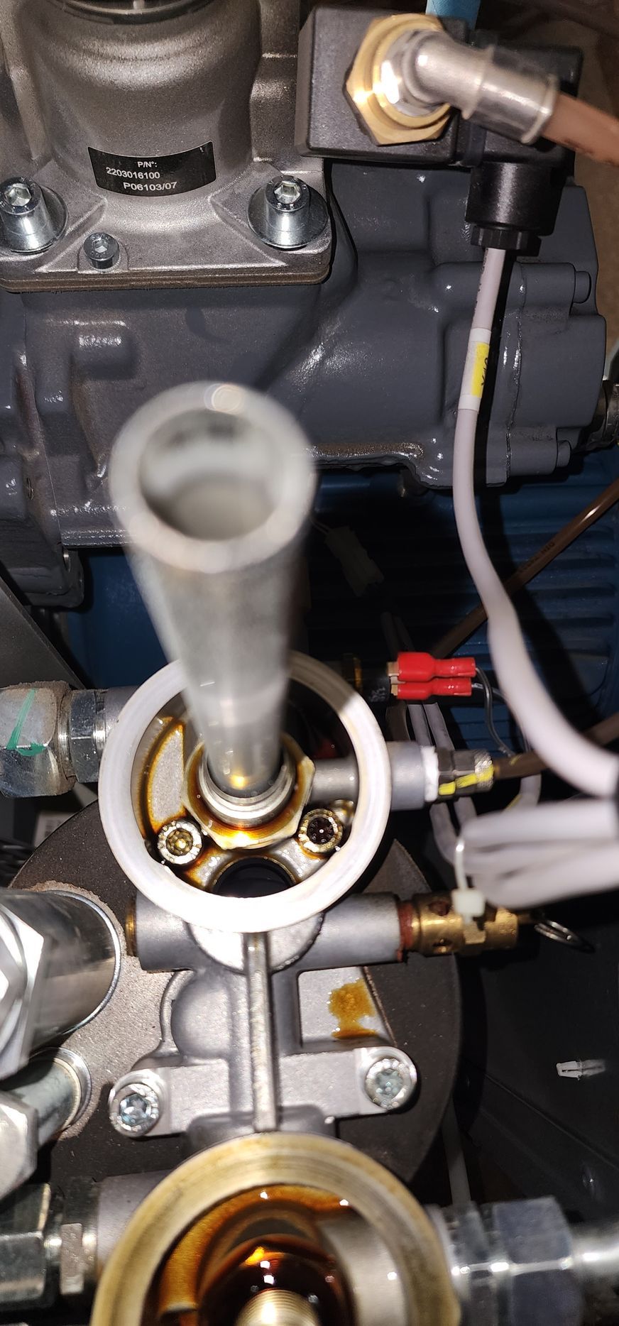 A close up of a fuel filter on a machine.