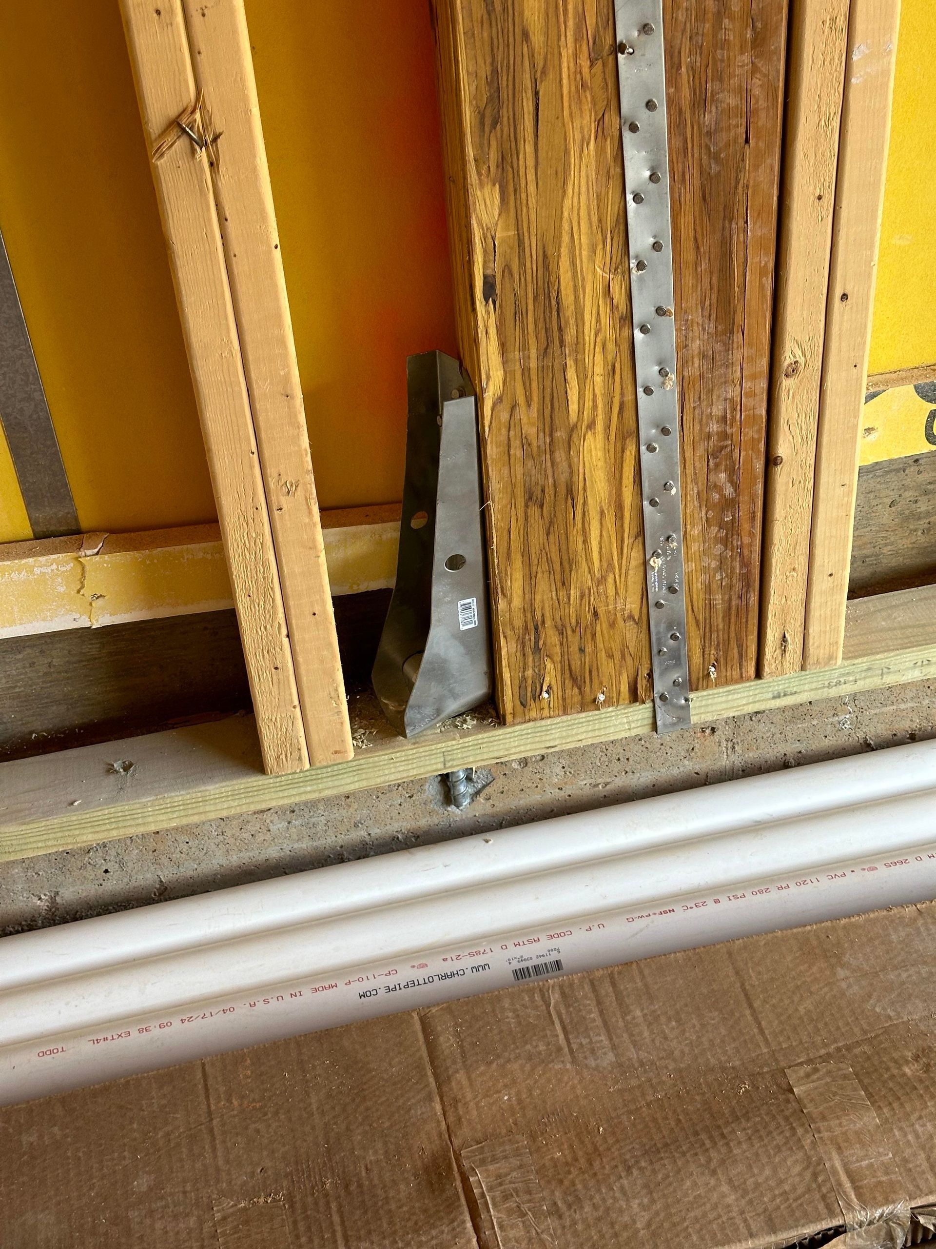A group of construction workers are standing in front of a building under construction.