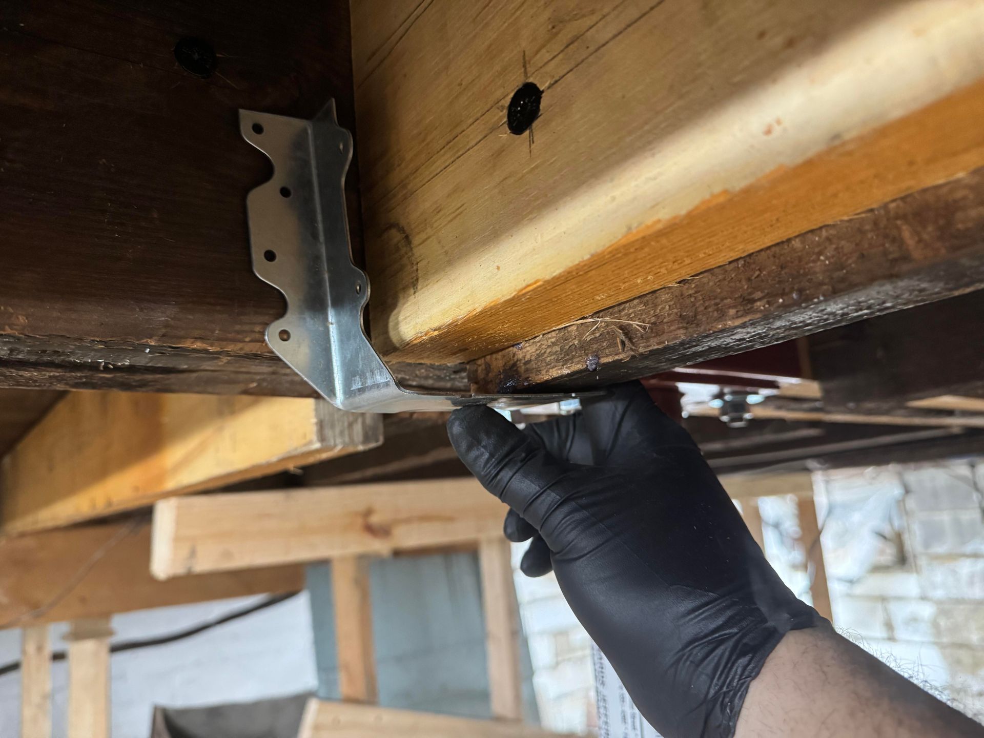 A crane is sitting on top of a building under construction.