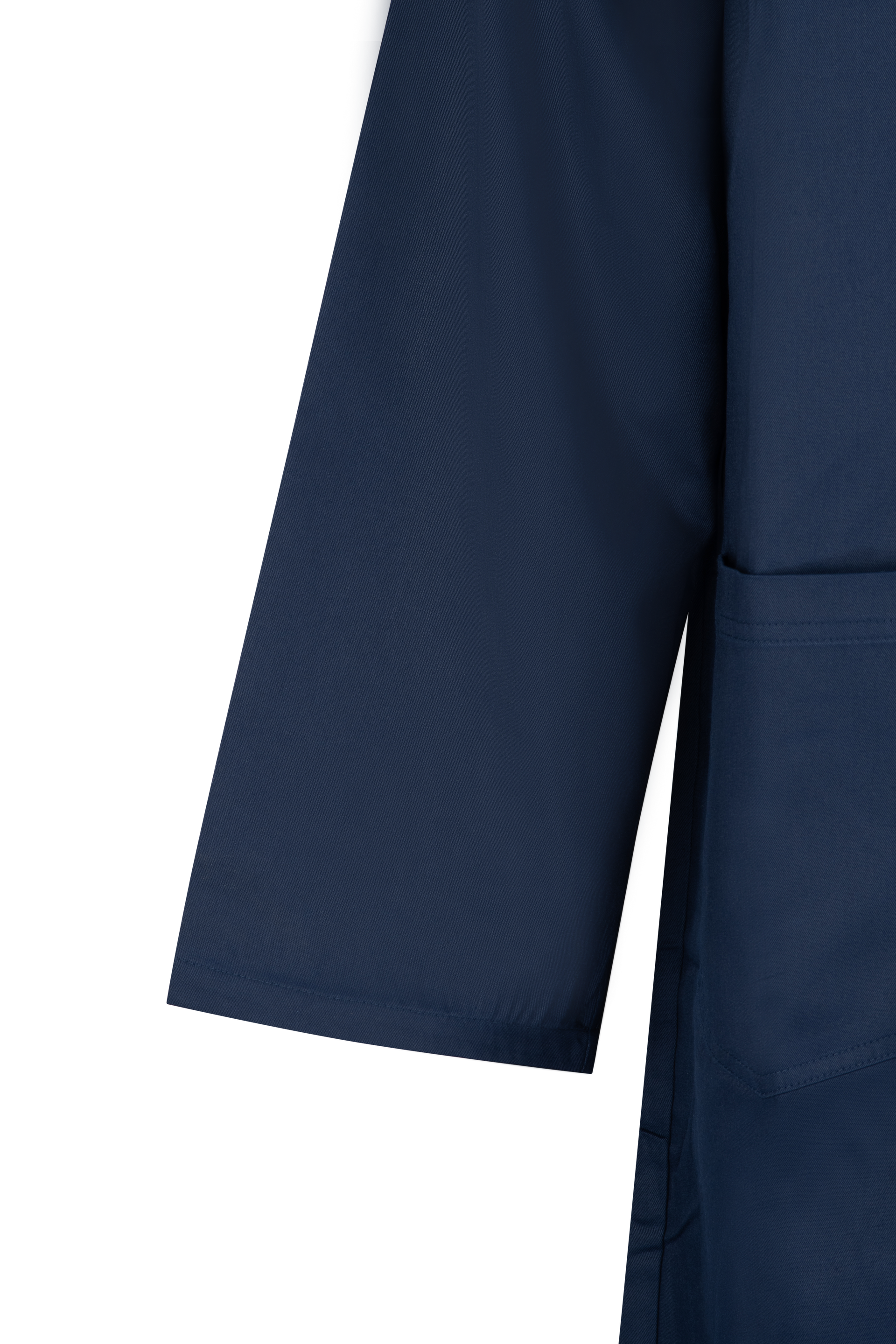 Dark blue sleeve of a coat, with a straight edge at the cuff.
