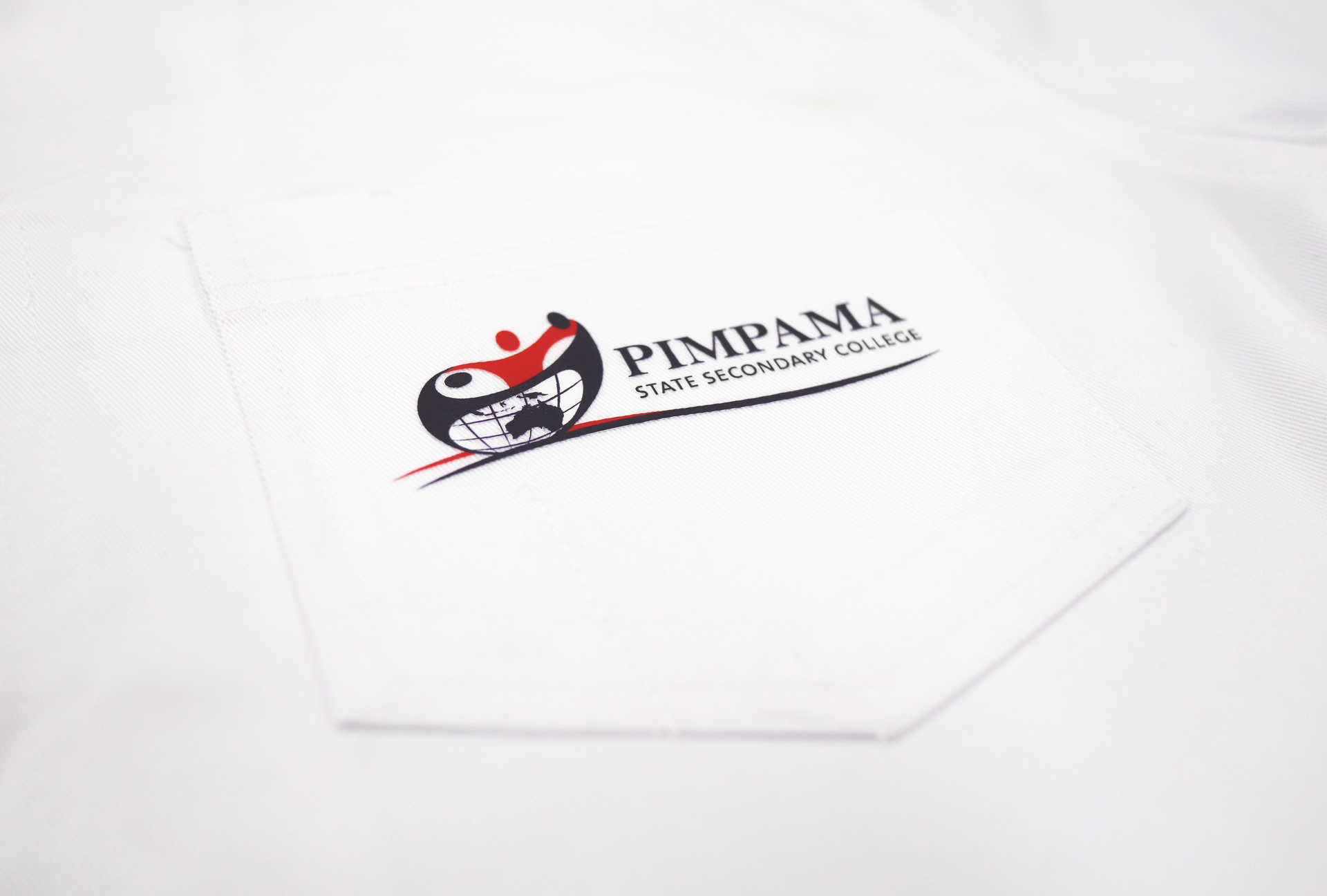 White lab coat pocket with the Pimpama State Secondary College logo printed on it.