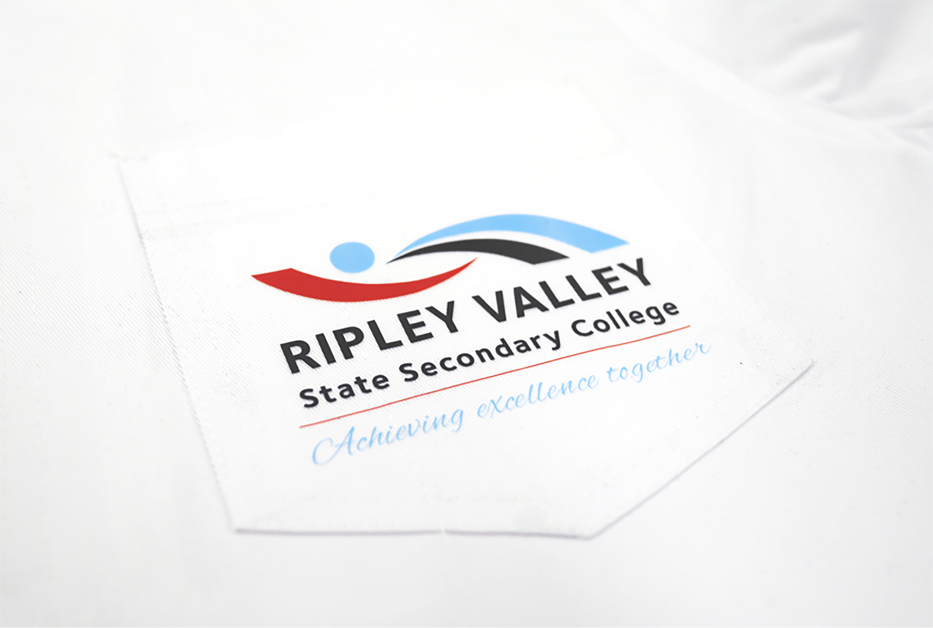 White shirt pocket with Ripley Valley State Secondary College logo.