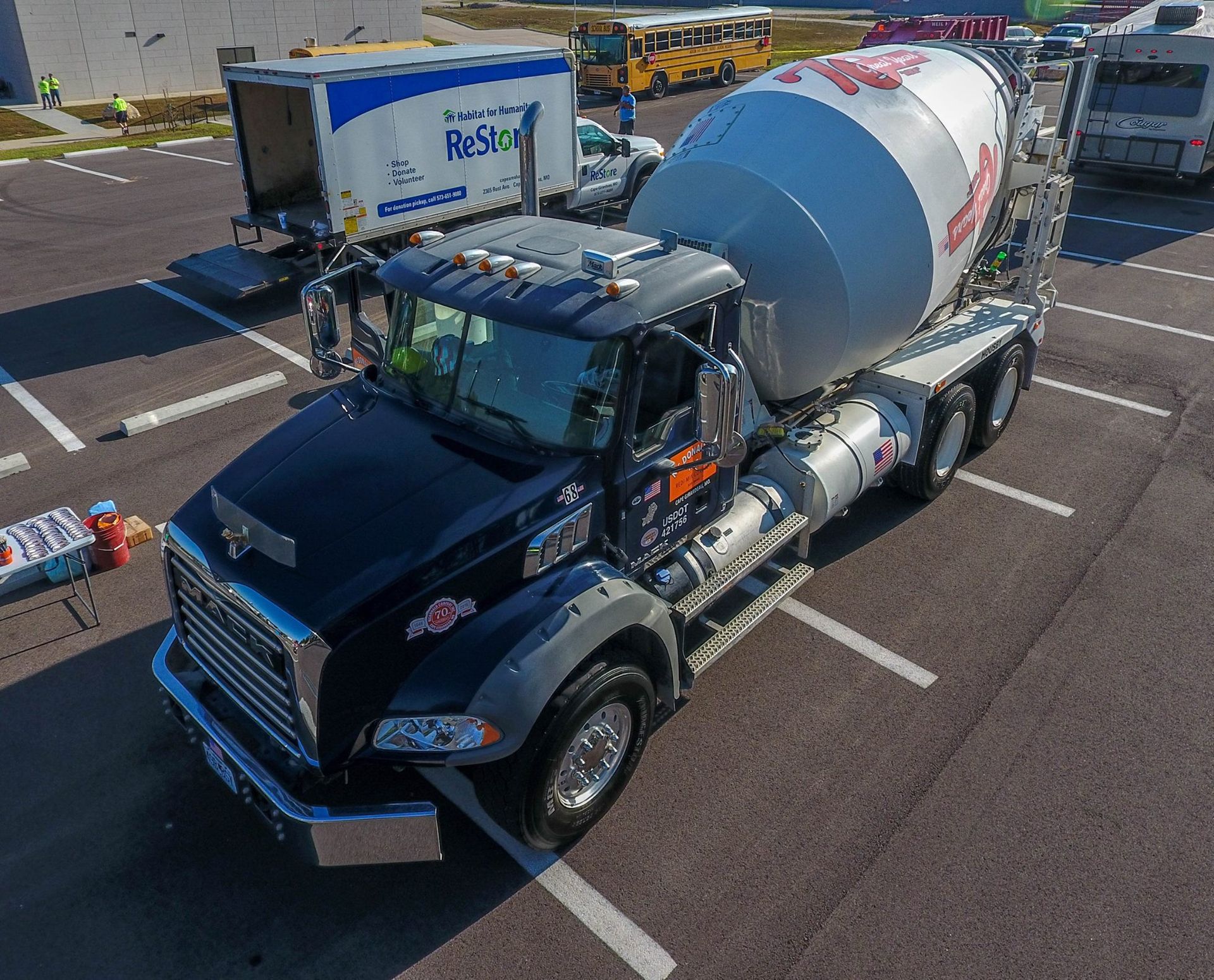 An aerial view of a concrete mixer truck parked in a parking lot.