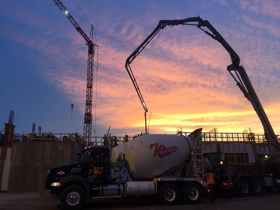 A mixer truck is pouring cement