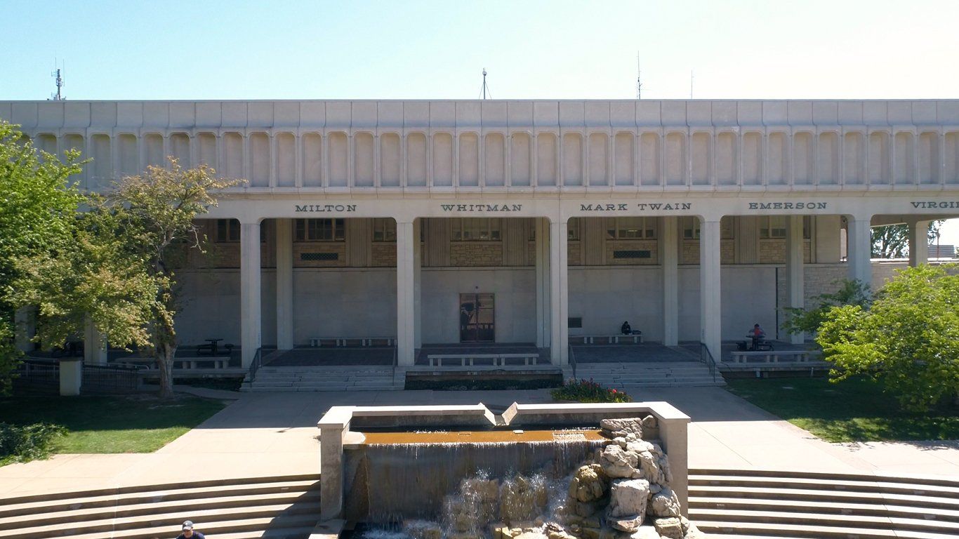 A large white building with a fountain in front of it