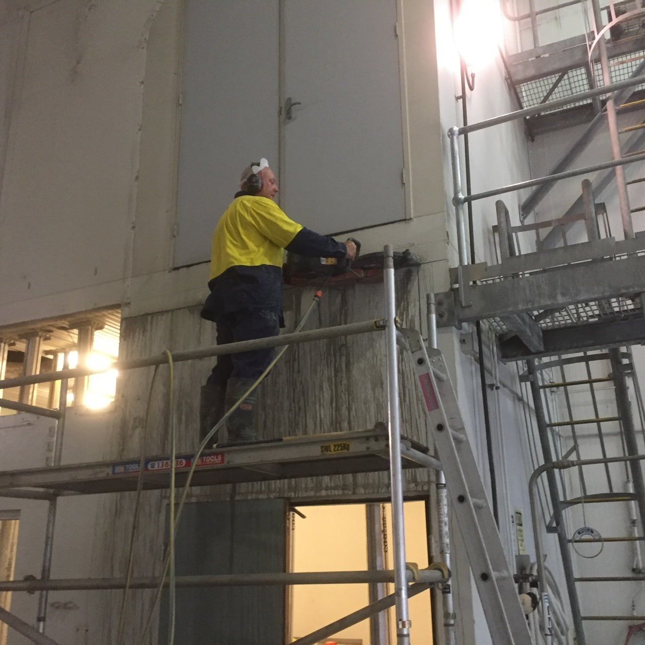 Man Holding A Concrete Cutter — Coastcut Concrete Cutting in Port Stephens, NSW