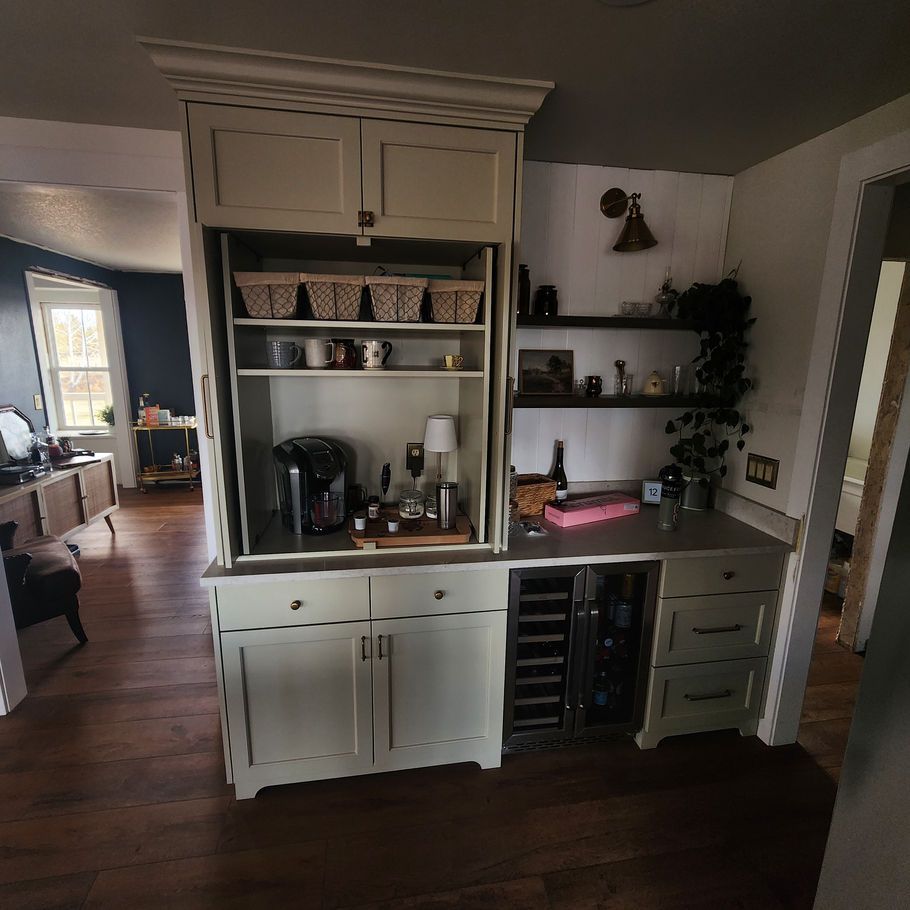 Built-in kitchen cabinet with a coffee station and wine fridge. Includes upper cabinets, open shelving, and a countertop.