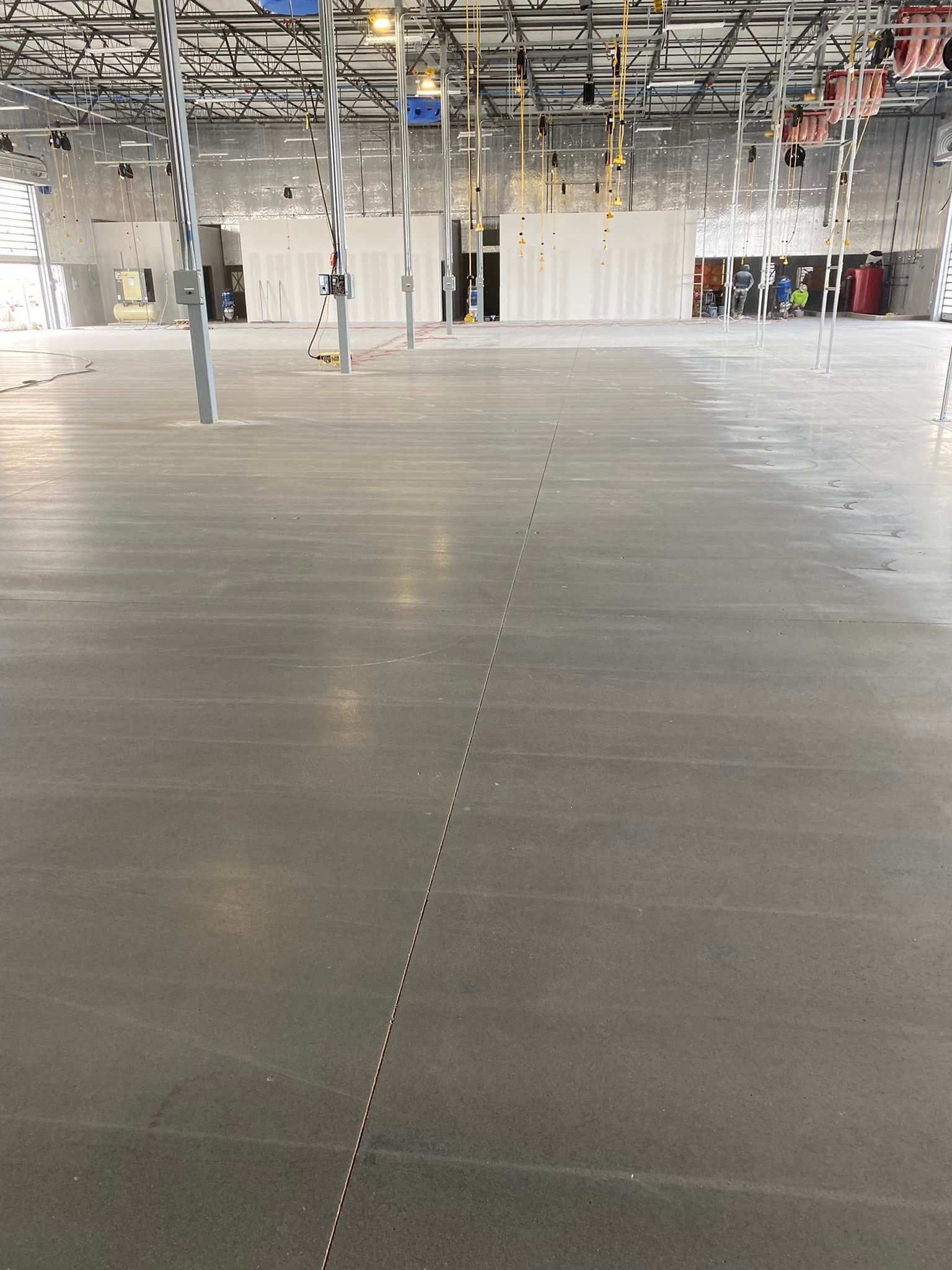 A large empty warehouse with a concrete floor