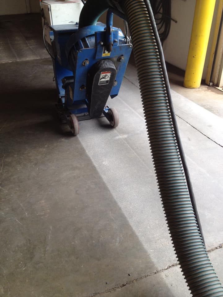 A vacuum hose is attached to a machine in a garage