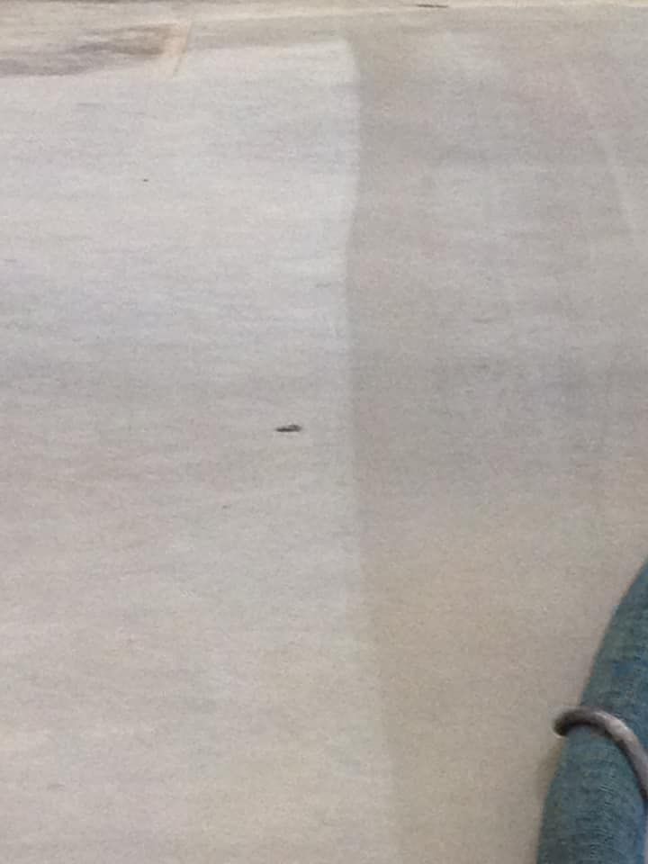 A close up of a white carpet with a shadow of a person on it.