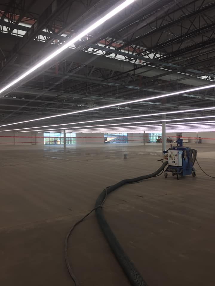 A large empty building with a vacuum cleaner in the middle of it.