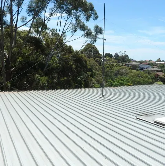 A House With a Flat Metal Roof — Wagga Roof Repairs In Mount Austin, NSW
