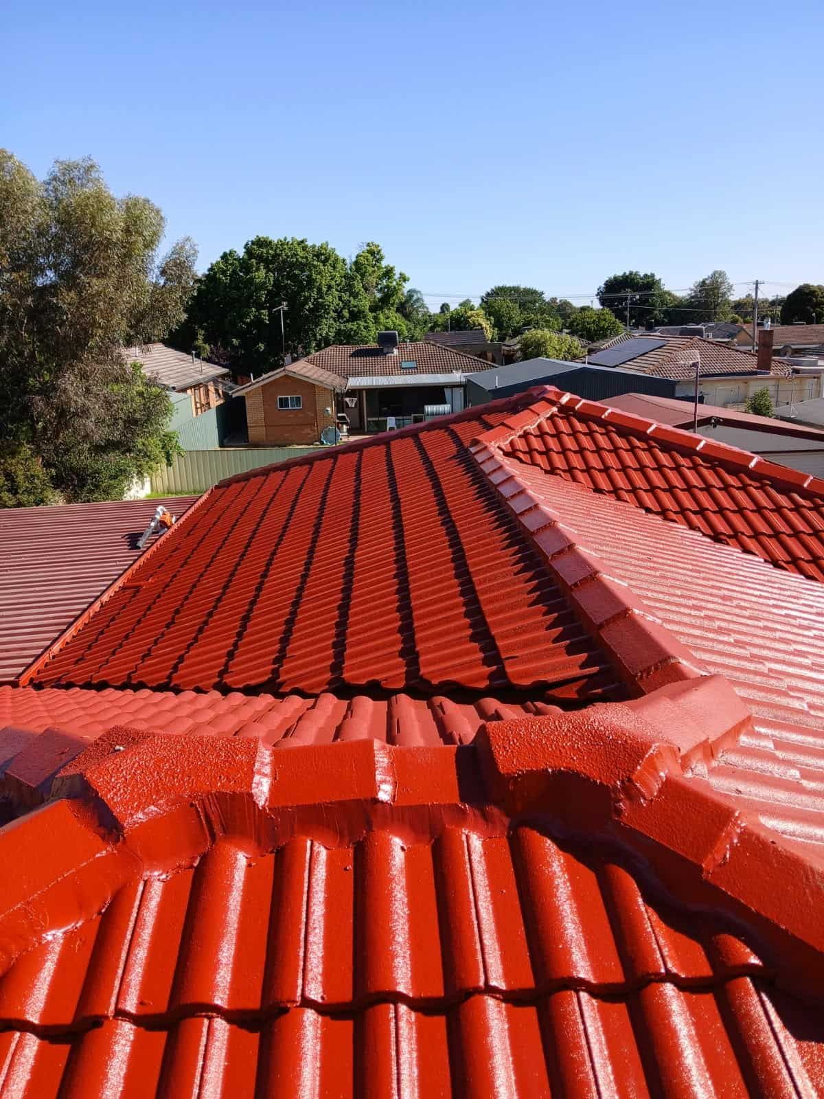 A Red Tiled Roof With a Blue Sky in the Background — Wagga Roof Repairs In Mount Austin, NSW