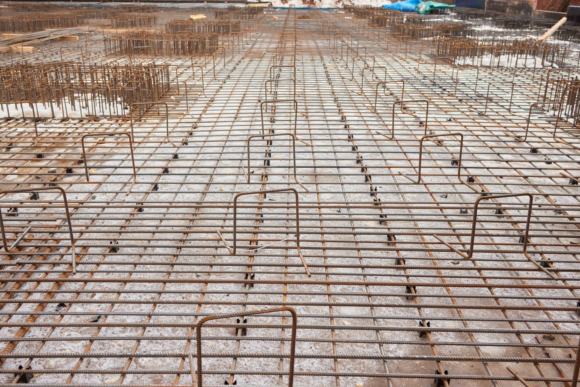 Steel rebar grid prepared for concrete pouring on a construction site.