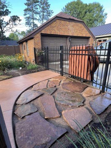 White house with a driveway. Palm trees and blue sky.