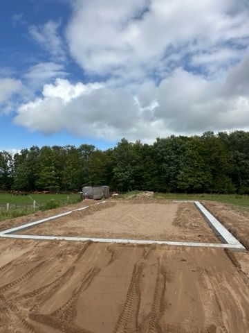 Concrete pool steps leading up from the water, with a gravel-filled trough alongside.