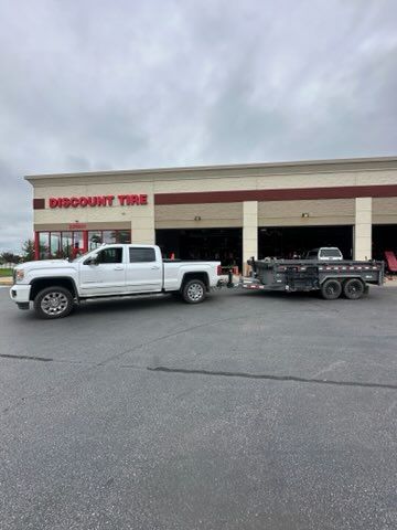 Strip mall with brick facade, glass storefronts, awnings, and accessible parking spaces.