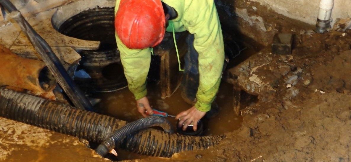 Man cleaning up sewer backup inlon 
