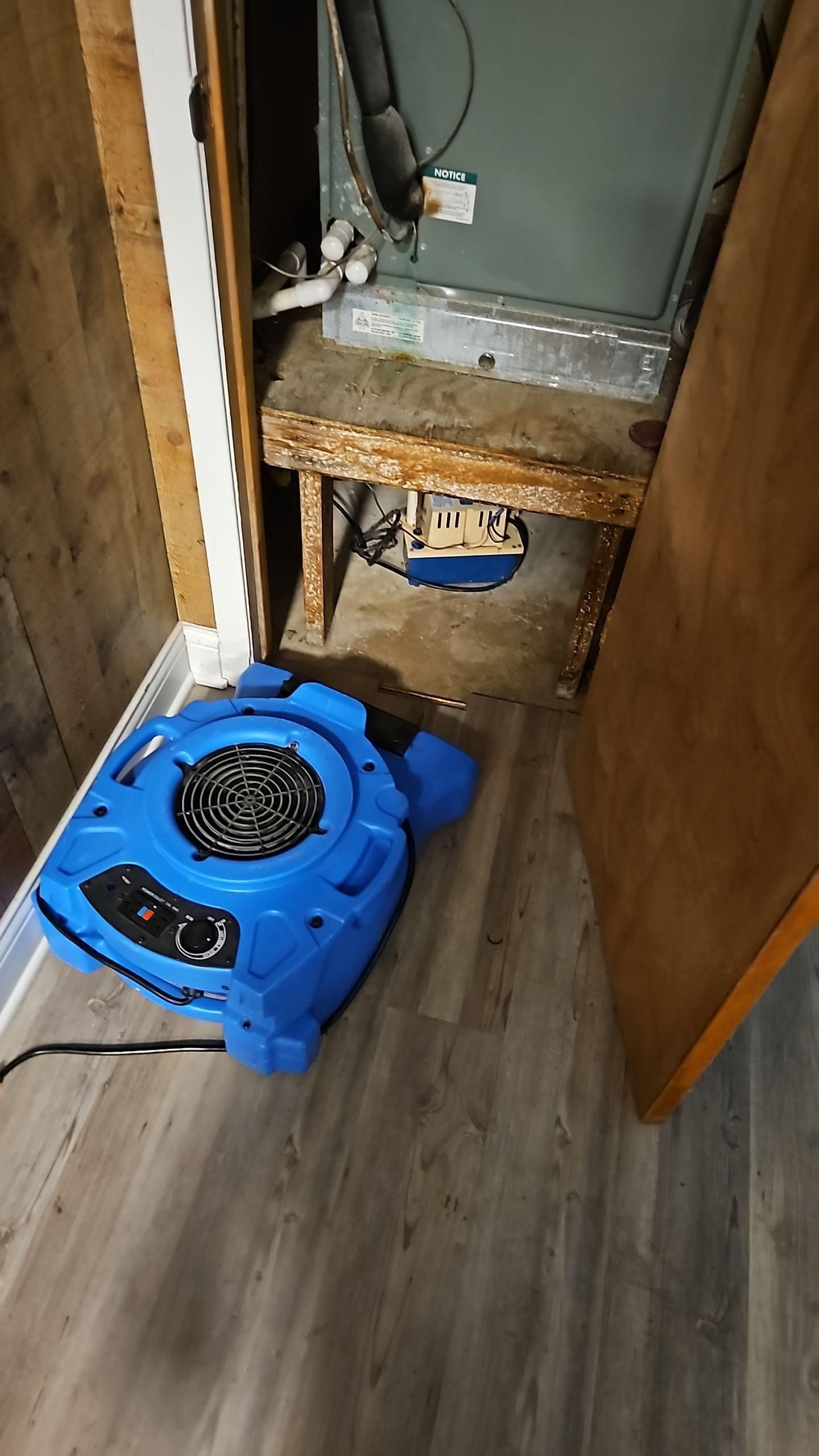 AC closet with professional drying equipment set up after leak