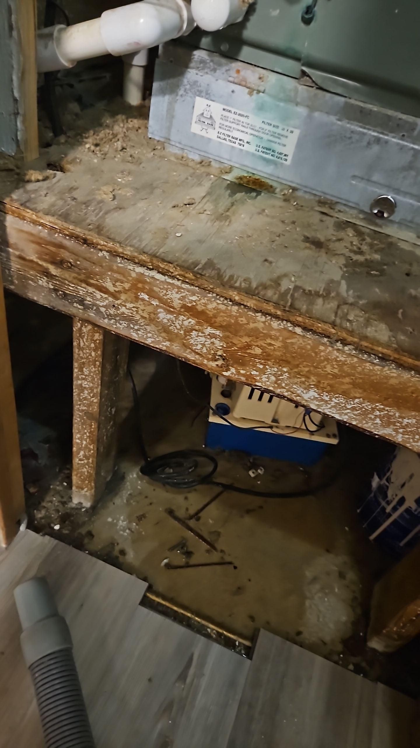 Water damage visible around AC unit in maintenance closet