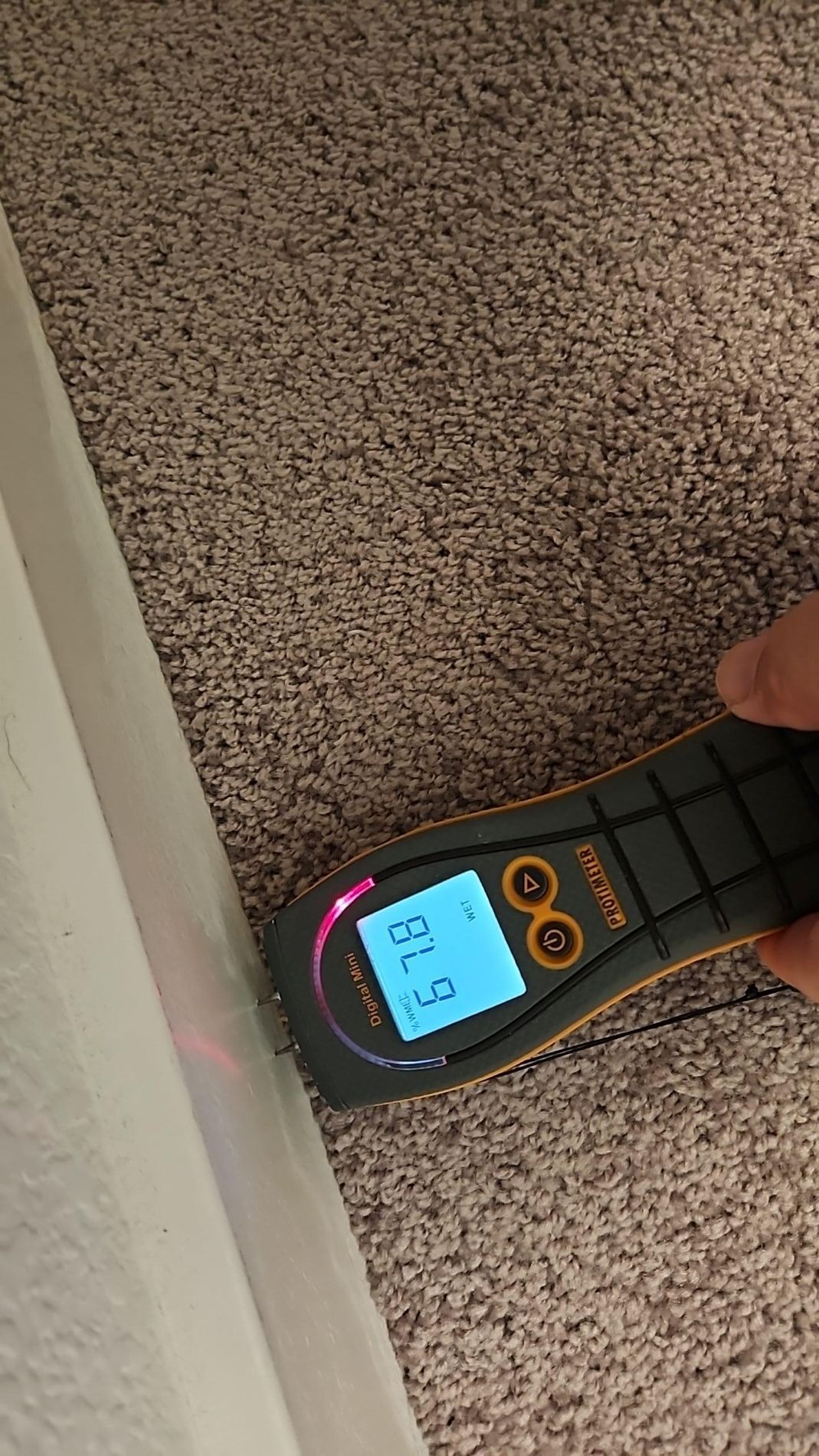 Bedroom water damage mitigation with drying equipment placed beneath carpet