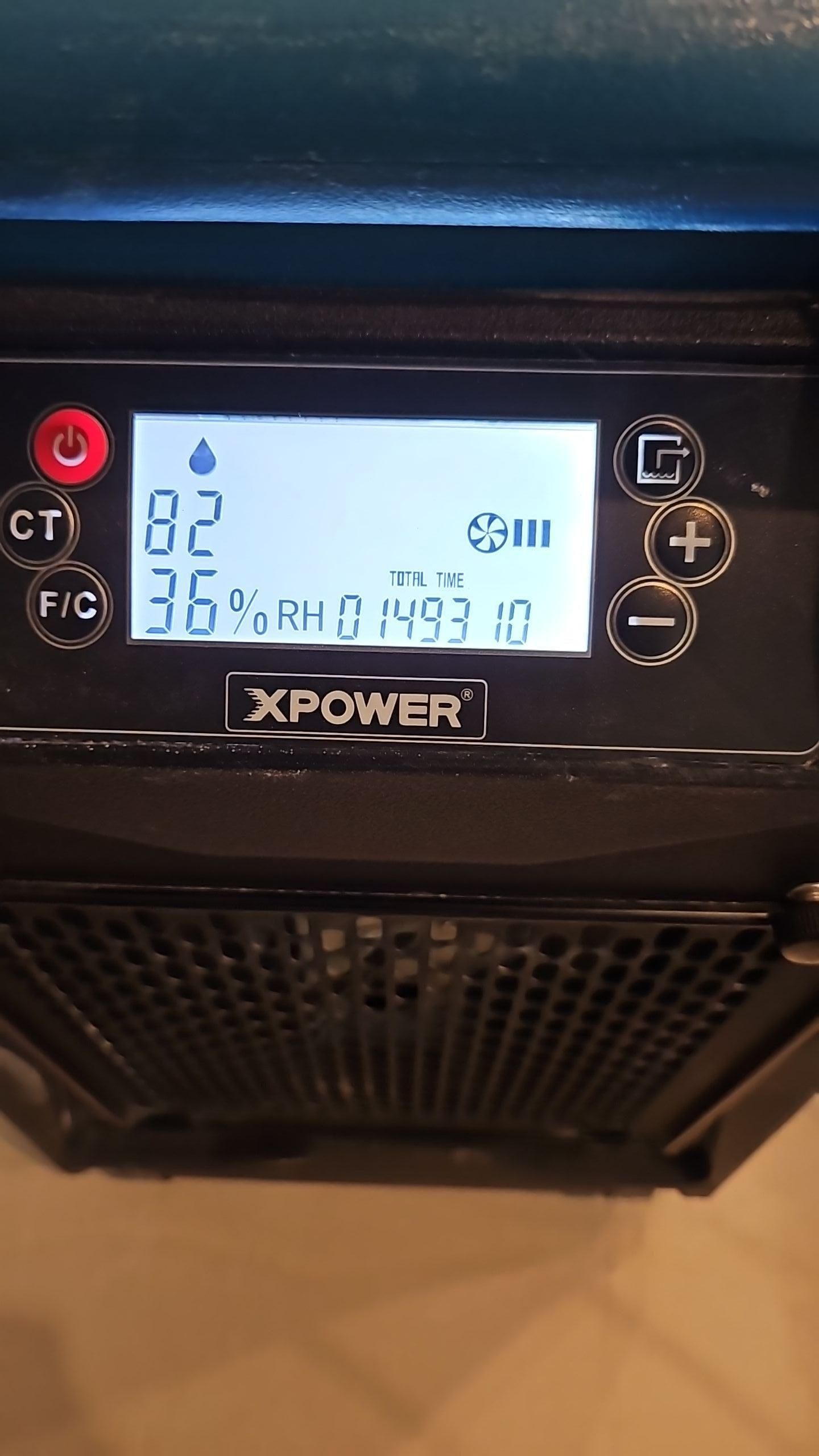 Industrial dehumidifier running during the water damage drying process