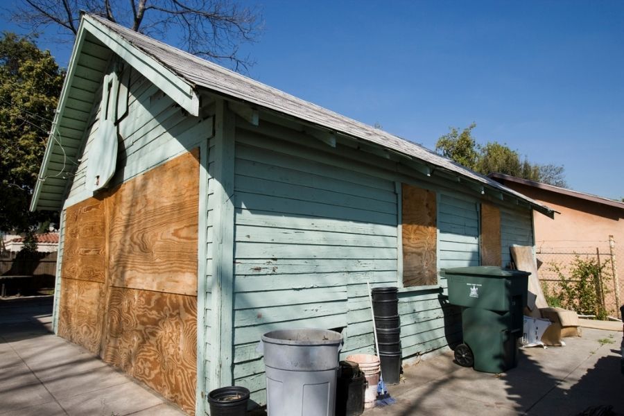 House with boarded up windows after fire damage