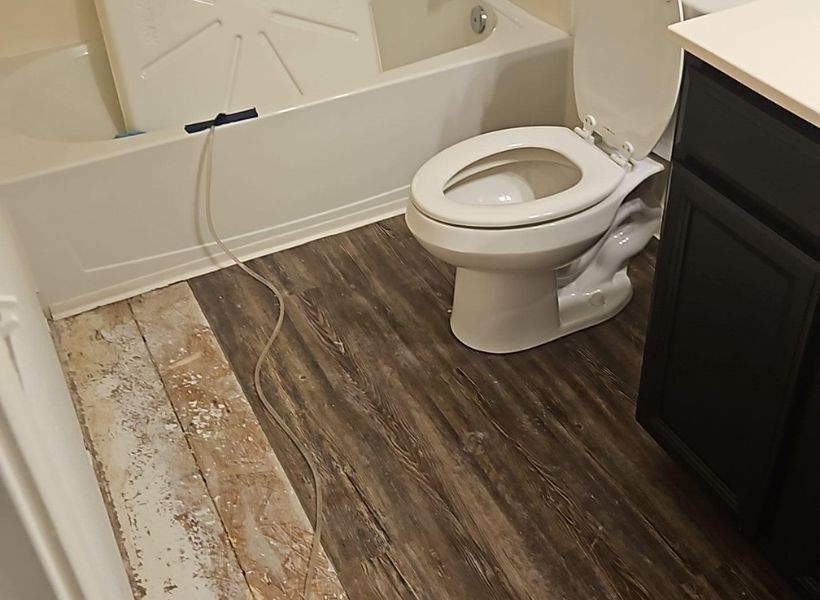 laminate flooring partially removed in the bathroom