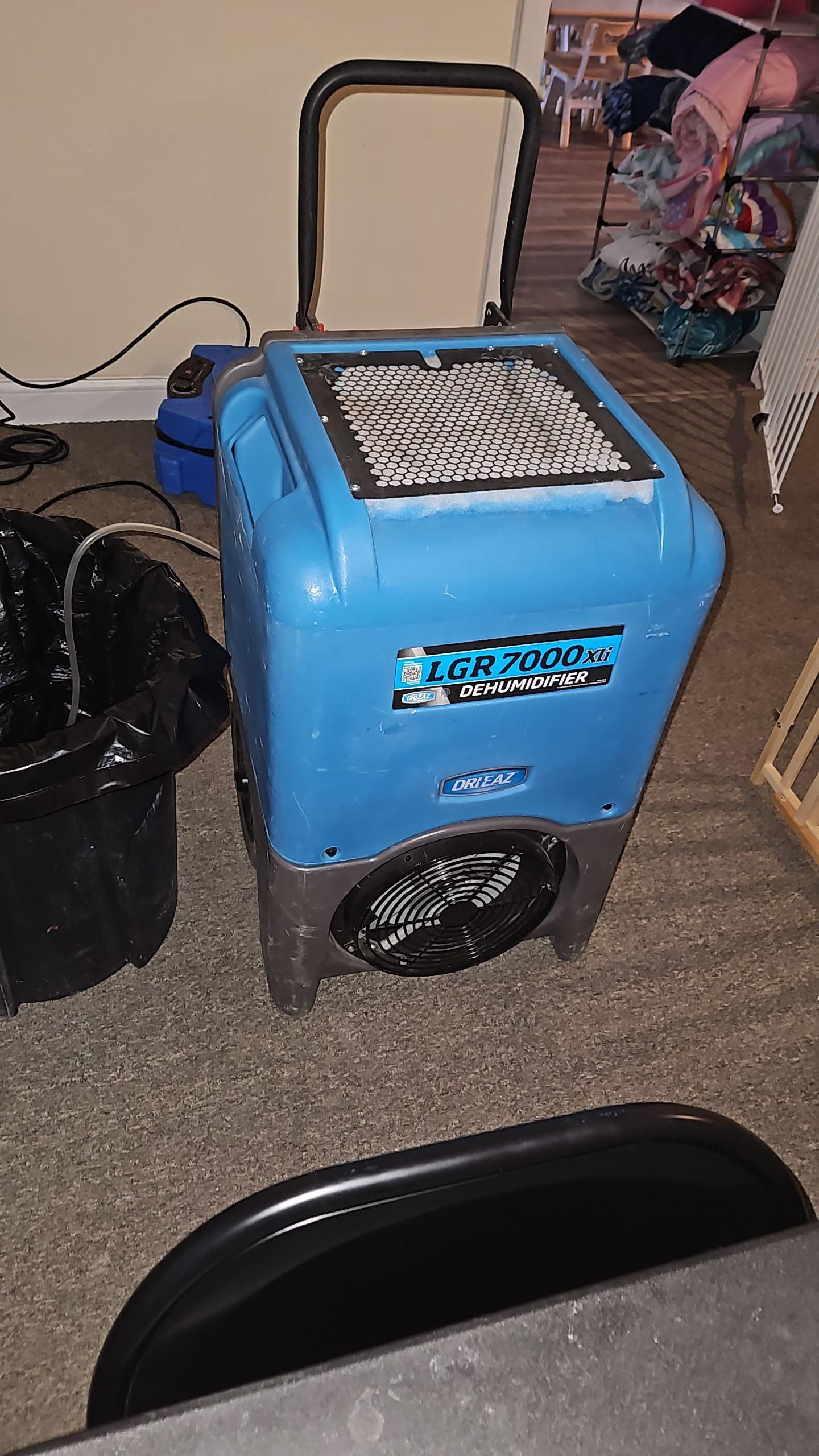 Industrial air movers positioned for optimal drying