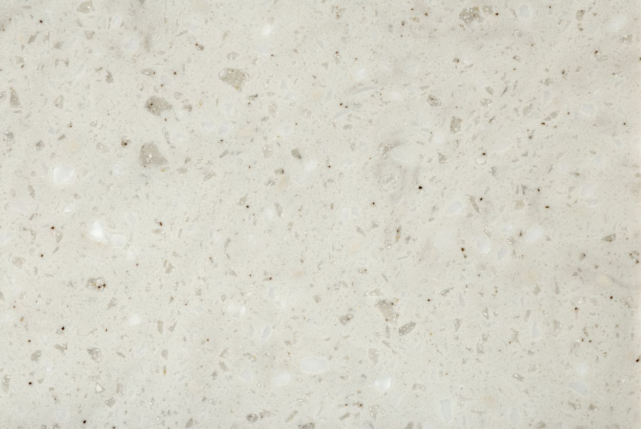 A close up of a white granite counter top.