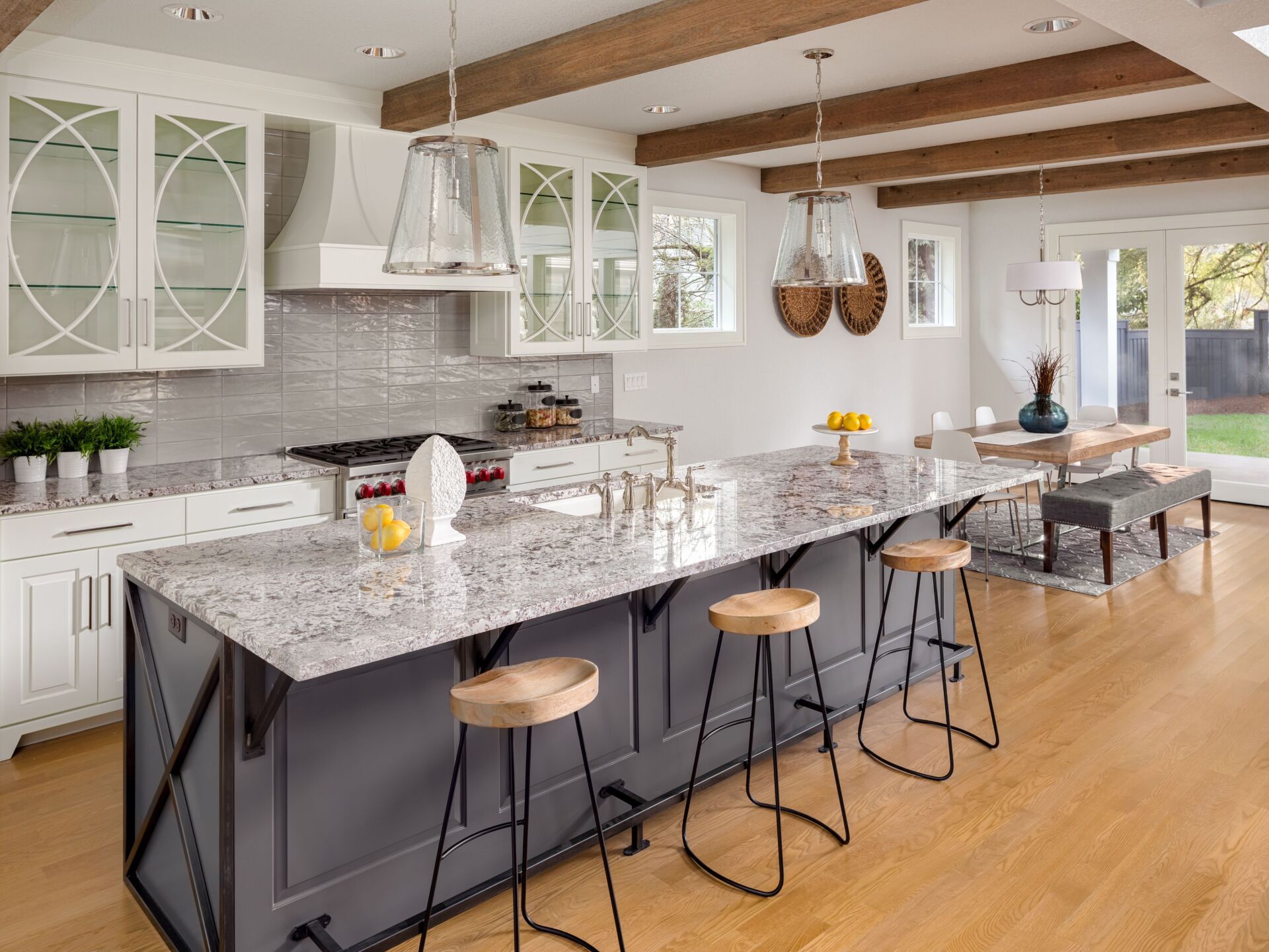 A kitchen with a large island and stools