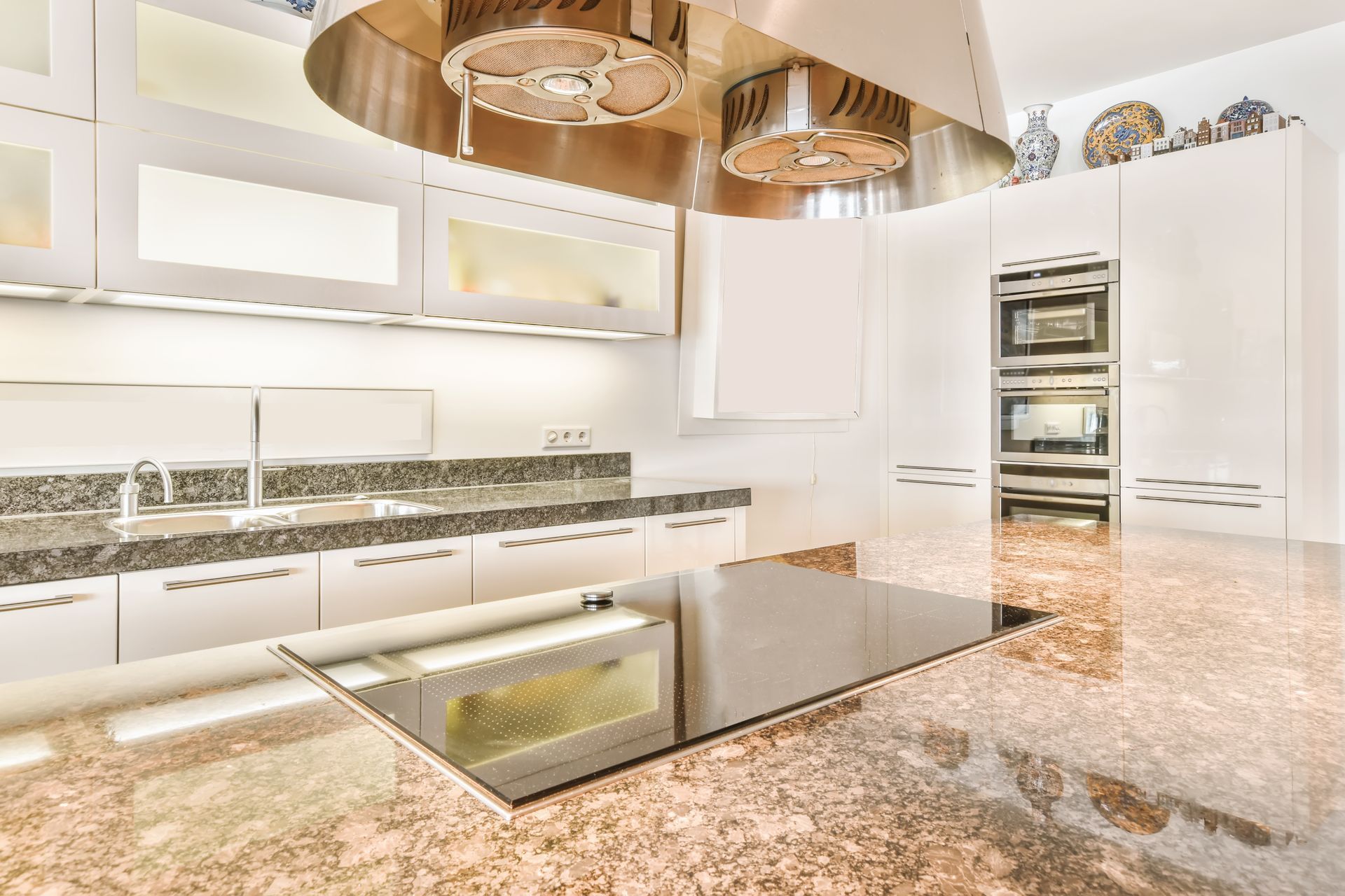 A kitchen with stainless steel appliances and granite counter tops.