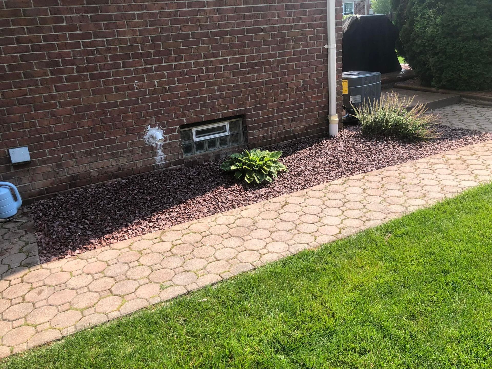 A brick walkway leading to a brick house