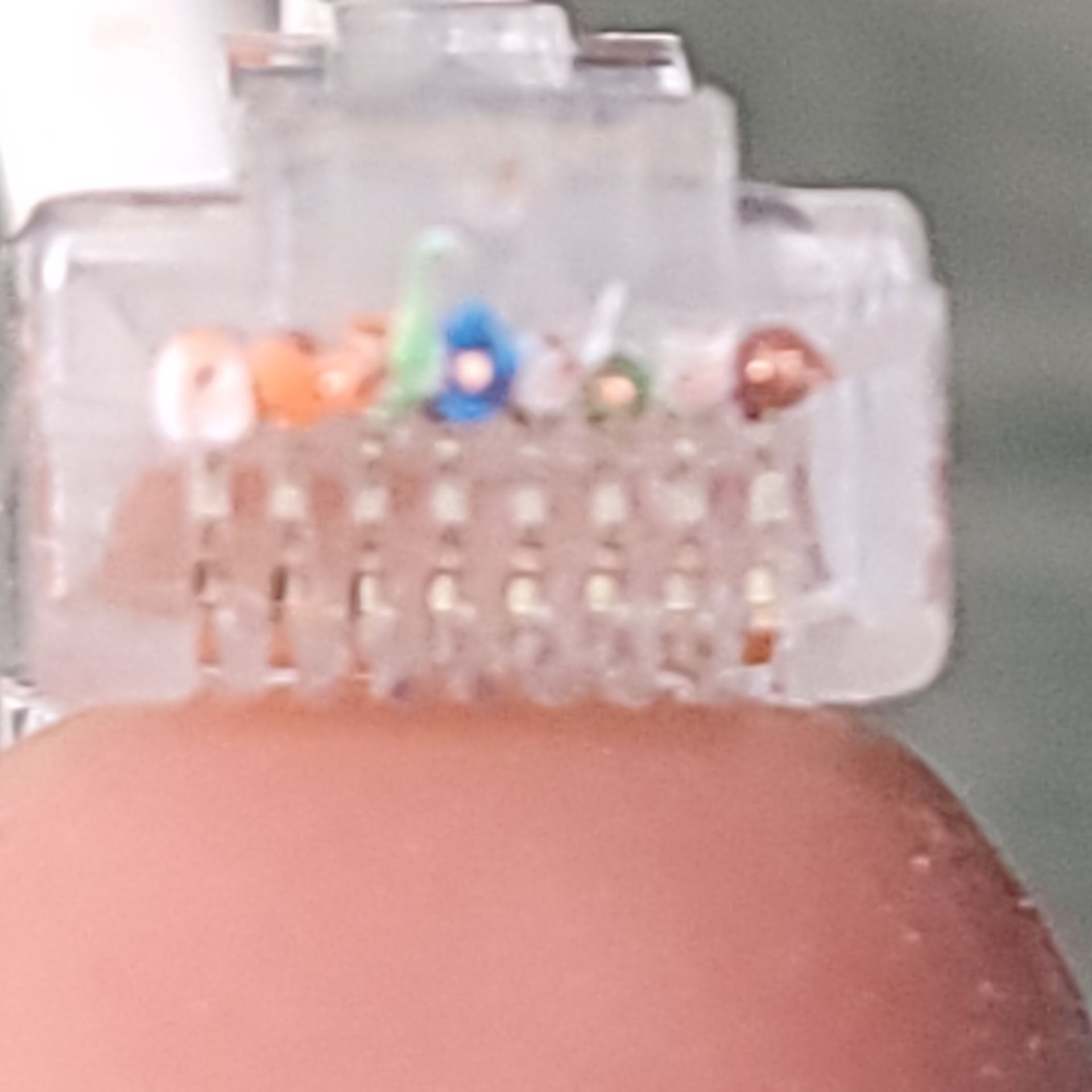 Close-up of an RJ45 connector showing the order of the wires
