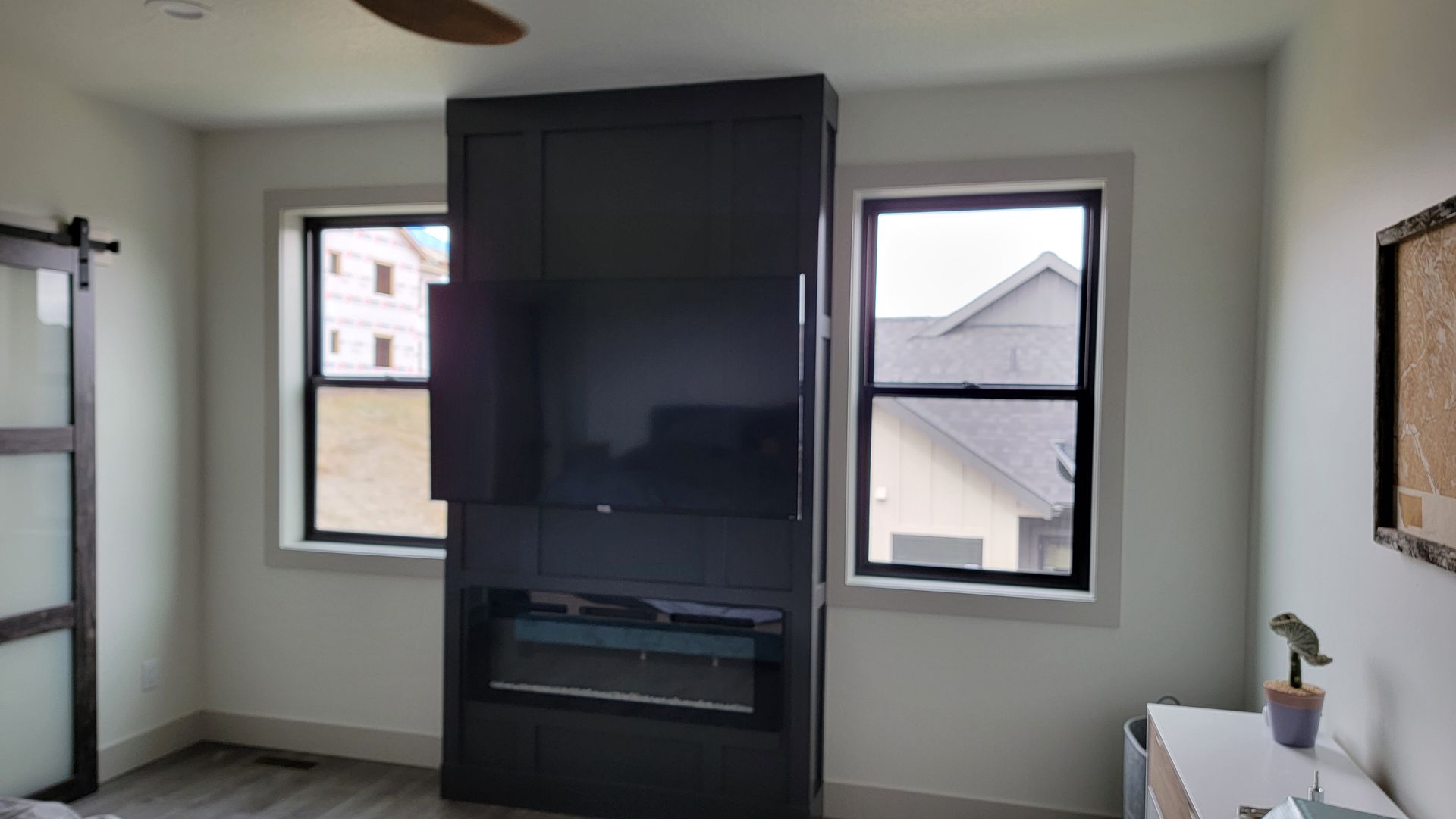 Bedroom TV installation above a modern fireplace in a Miller Creek home near Missoula, Montana
