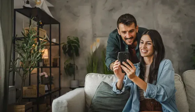 Happy couple using a smart home app together
