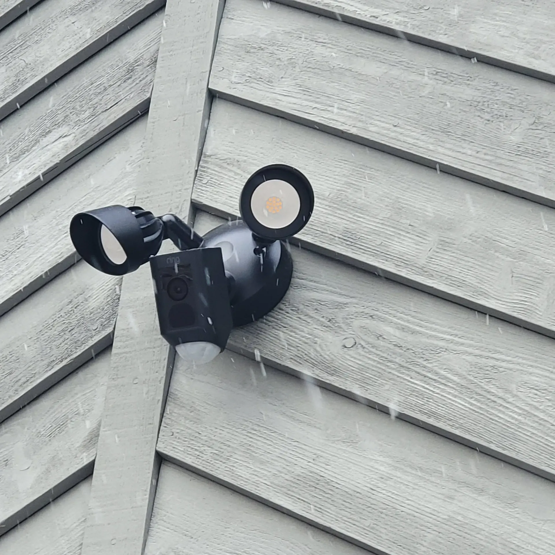 Ring dual floodlight security camera mounted on Missoula Montana home exterior for night vision surveillance