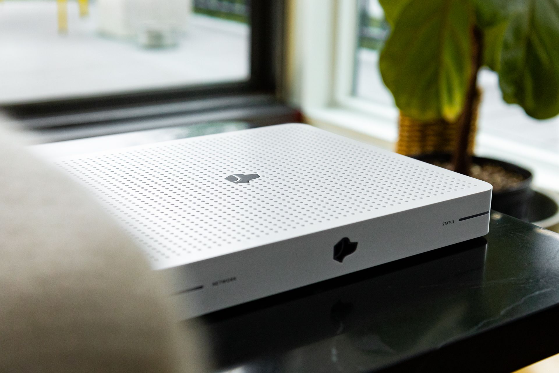 Close-up of the Josh One smart home controller on a tabletop in a modern interior